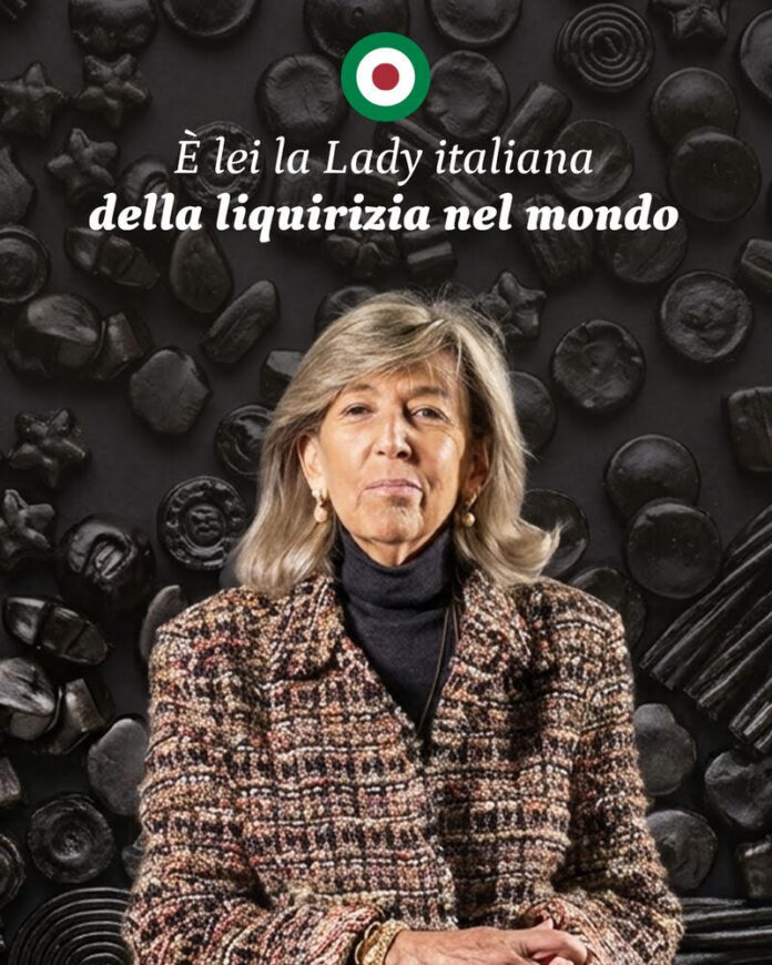 Pina Amarelli davanti a uno sfondo con motivi di liquirizia, immagine che illustra il racconto della sua leadership nel settore della liquirizia italiana.