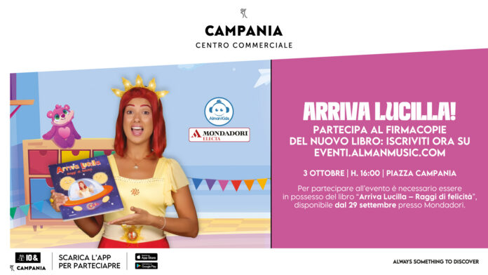 Lucilla, fatina del sole, che tiene in mano il suo nuovo libro durante un evento al Centro Campania, con sfondo colorato e elementi di festa.
