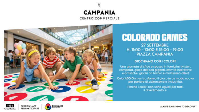Bambini che giocano a Twister gigante in un centro commerciale durante un evento inclusivo sul daltonismo.
