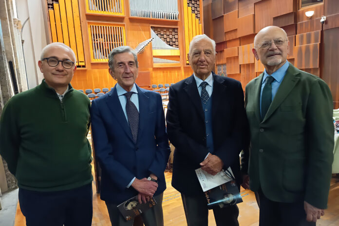 Quattro uomini in una sala con arredi in legno, foto di archivio associata all'Associazione Alessandro Scarlatti di Napoli